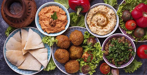 Selection of Middle eastern or Arabic dishes. Falafel, hummus, pita and muhammara. Top view