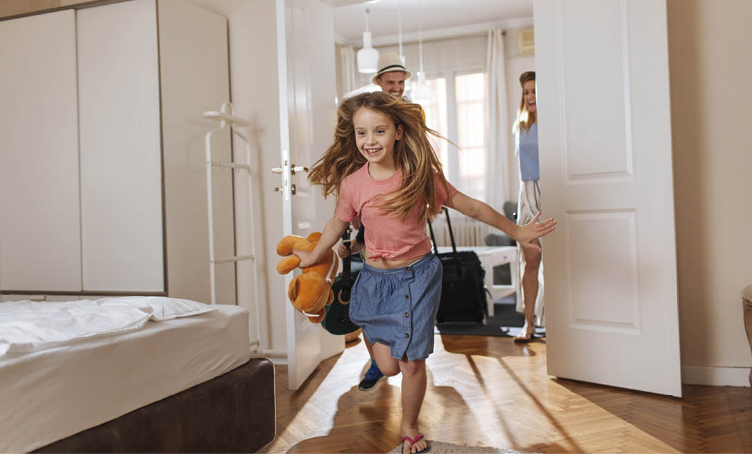 Shot of a happy family entering their accomodation
