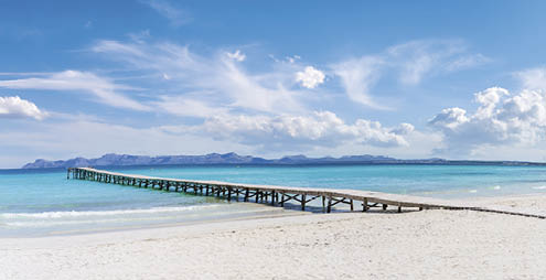 Landscape with boardwalk at the coastline of Platja de Muro in Alcudia bay, Majorca Island, Spain