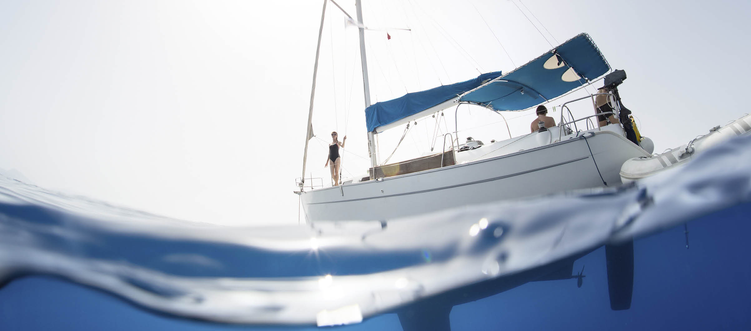 Split shot of the sail boat on surface and its underwater view