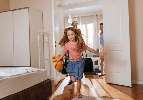 Shot of a happy family entering their accomodation