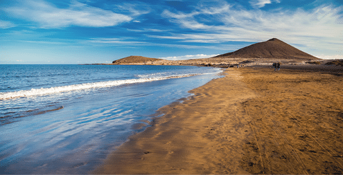 view of Playa el Medano beach with Montana Roja mountain on the background, Tenerife, Canary islands, Spain