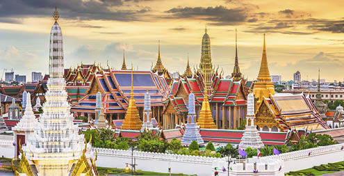 Bangkok, Thailand at the Temple of the Emerald Buddha and Grand Palace at dusk.