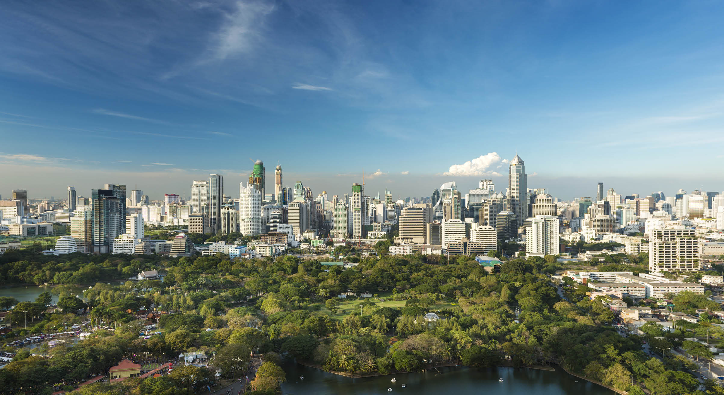 Lumphini Park and the downtown Bangkok City Skyline Thailand