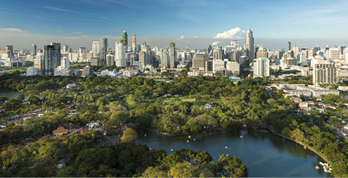 Lumphini Park and the downtown Bangkok City Skyline Thailand