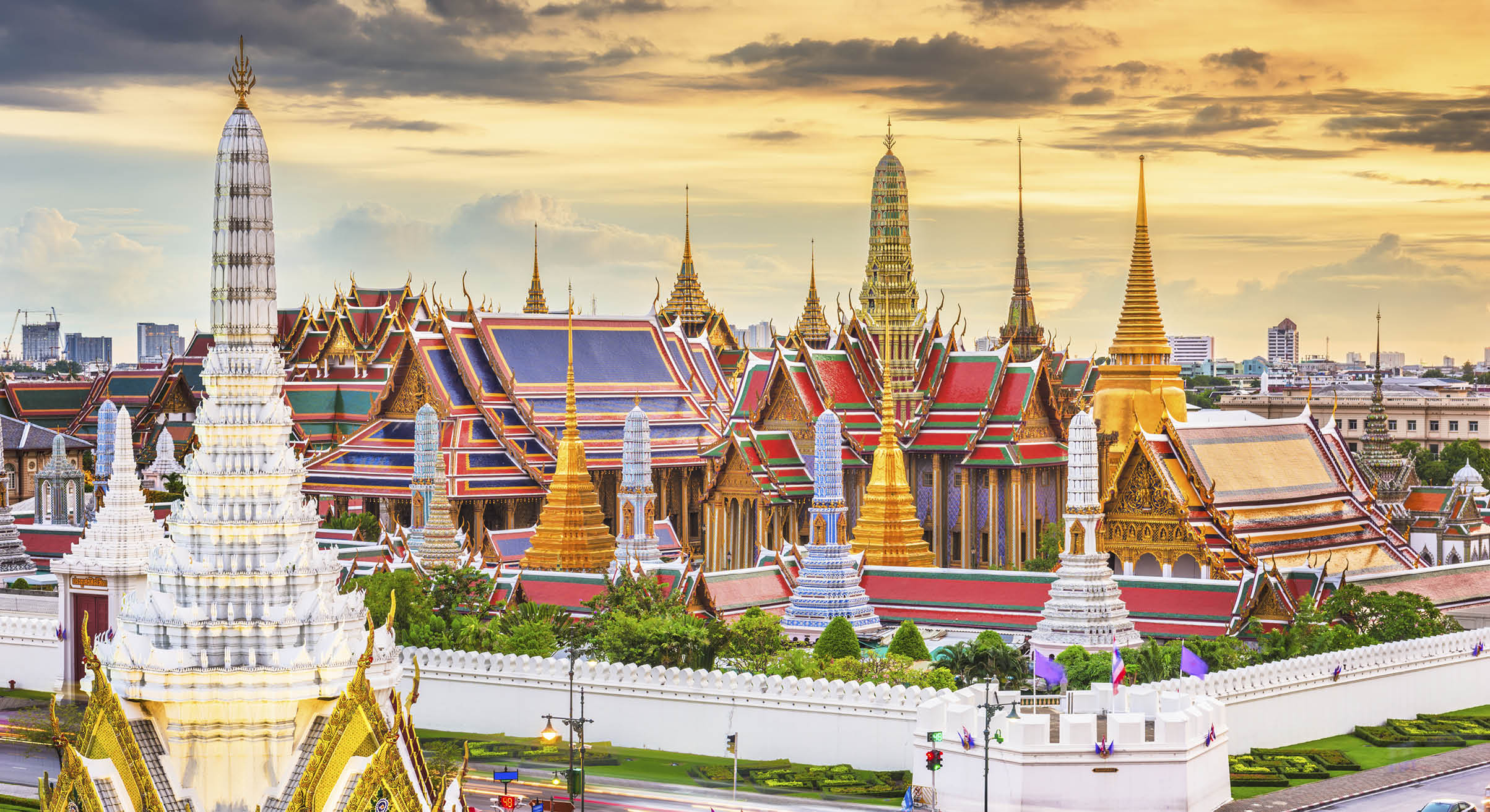 Bangkok, Thailand at the Temple of the Emerald Buddha and Grand Palace at dusk.