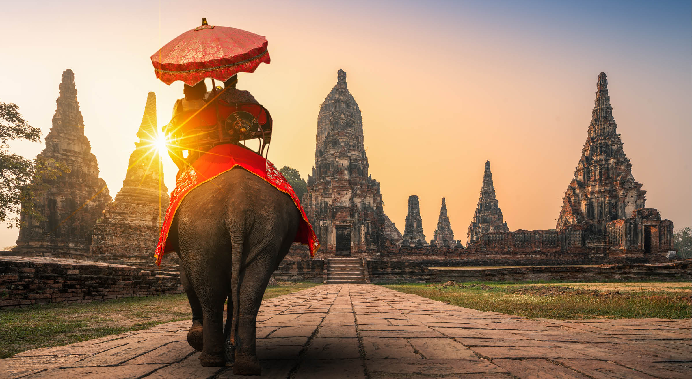 Tourists With an Elephant at Wat Chaiwatthanaram temple in Ayutthaya Historical Park, a UNESCO world heritage site in Thailand“n