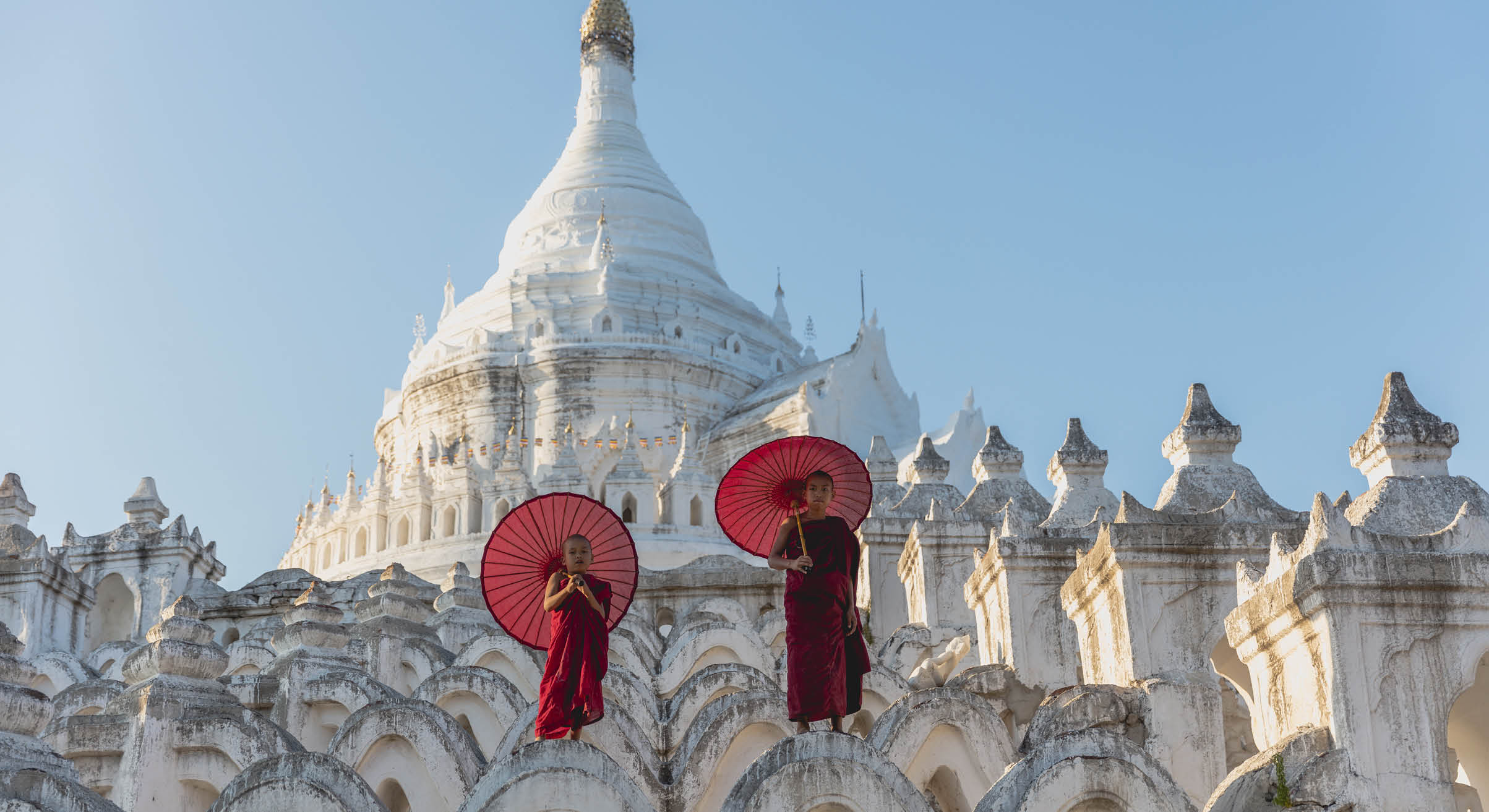 Novices under umbrellas at historic temple, Mingun, Mandalay, Myanmar