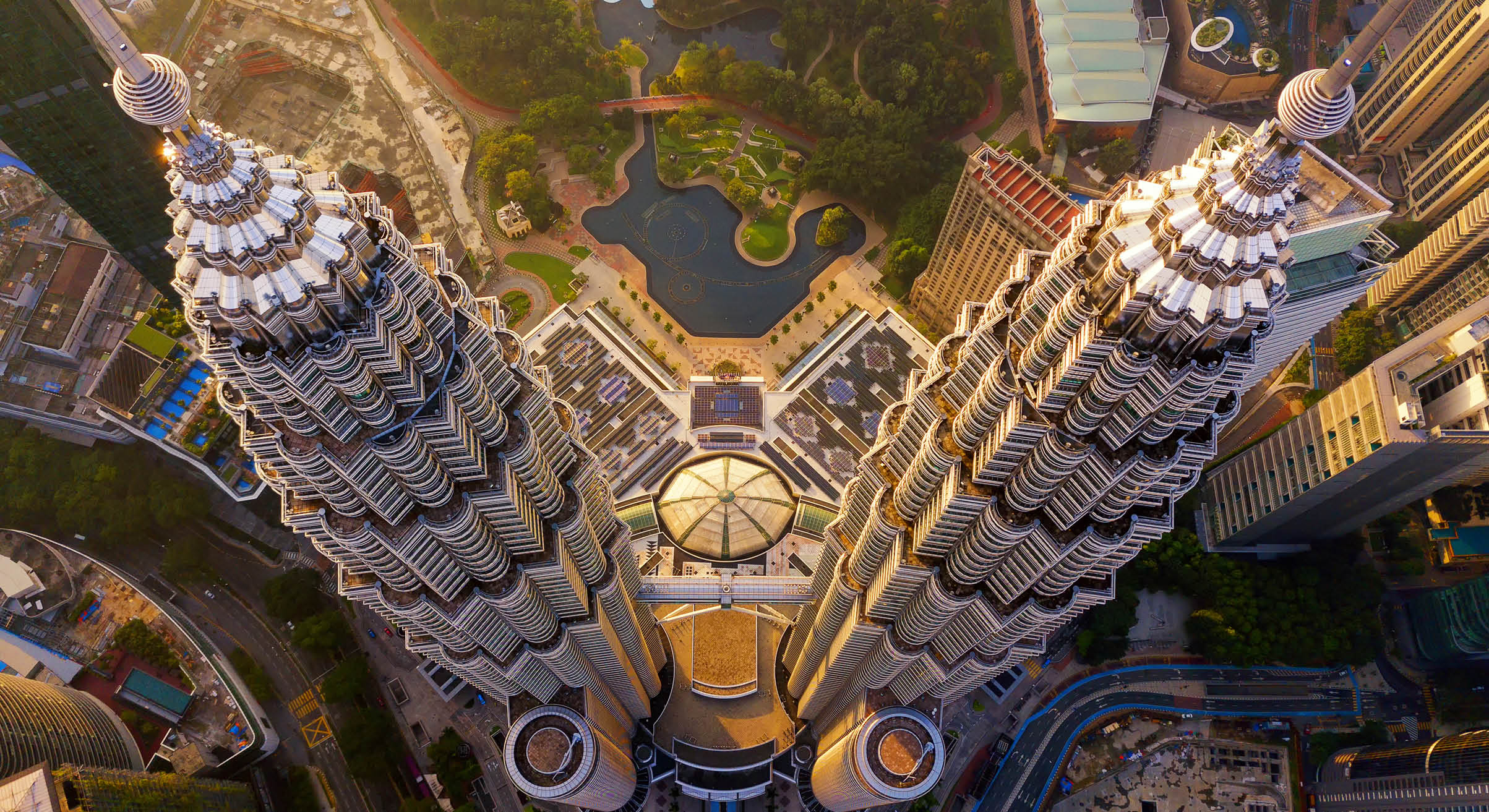 Top of Petronas Twin Towers. Aerial view of Kuala Lumpur Downtown, Malaysia. Financial district and business centers in smart urban city in Asia. Skyscraper and high-rise buildings at sunset.