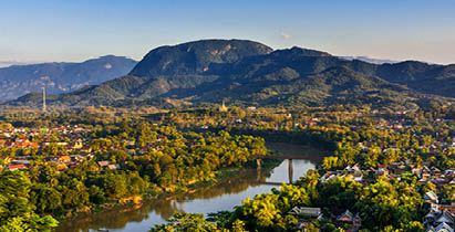 Luang Prabang, Laos, Southeast Asia: Landscape view over the city in the sunset lights from Mount Phousi, a sacred mountain located in the heart of the former capital of Laos