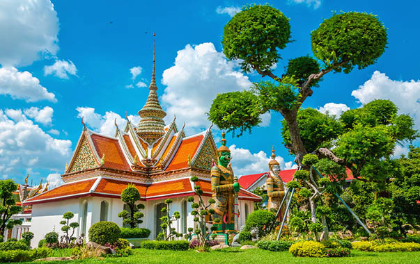 Great Palace Buddhist temple with famous green tree gardens in center of Bangkok, Thailand