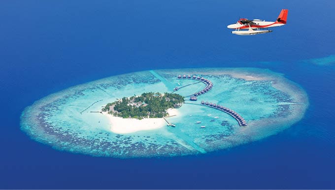 Sea plane flying above Maldives islands