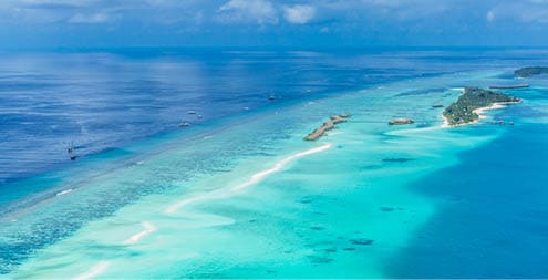 Aerial view on Maldives island, Ari atoll  Tropical islands and atolls in Maldives from aerial view  Summer vacation holiday landscape background 