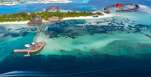 Aerial view, paraglider flies along an atoll of Maldives, South Male Atoll Maldives
