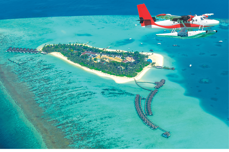 Aerial view of a seaplane approaching island in the Maldives