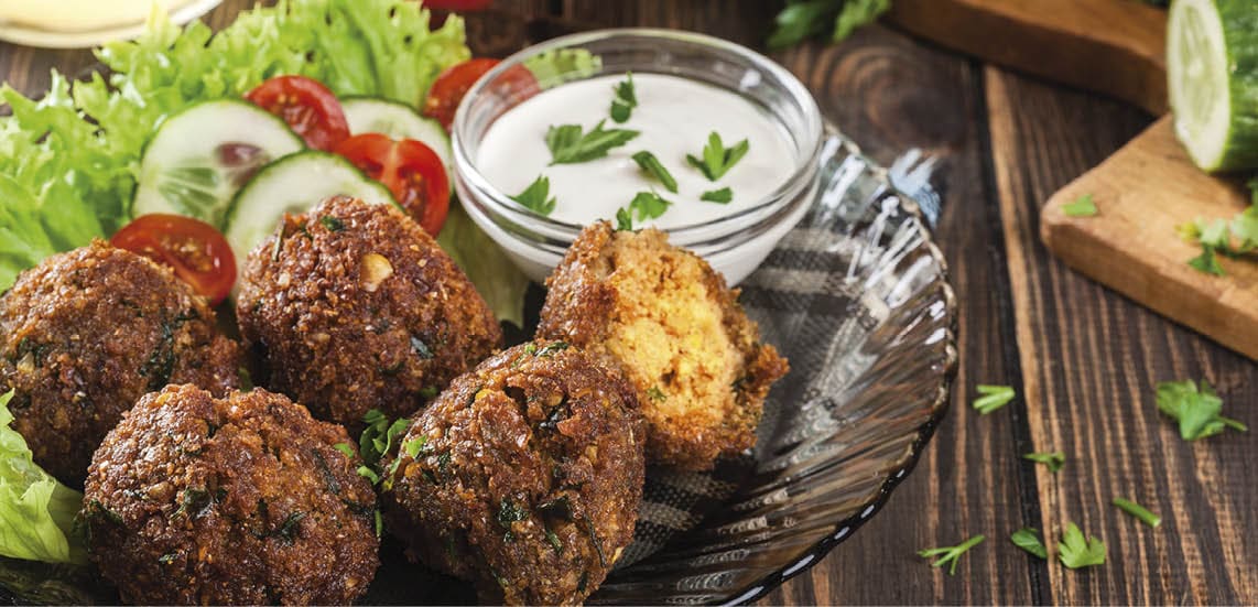 Chickpea falafel balls on a plate with vegetables