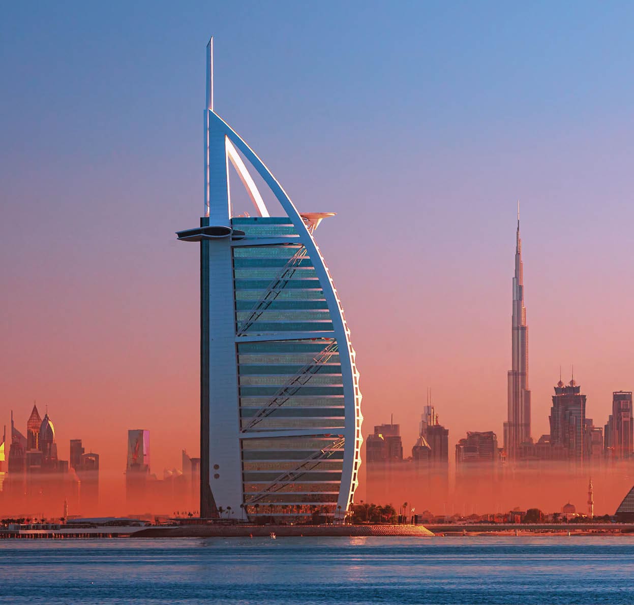 Dubai city - amazing city center skyline and famous Jumeirah beach at sunset, United Arab Emirates