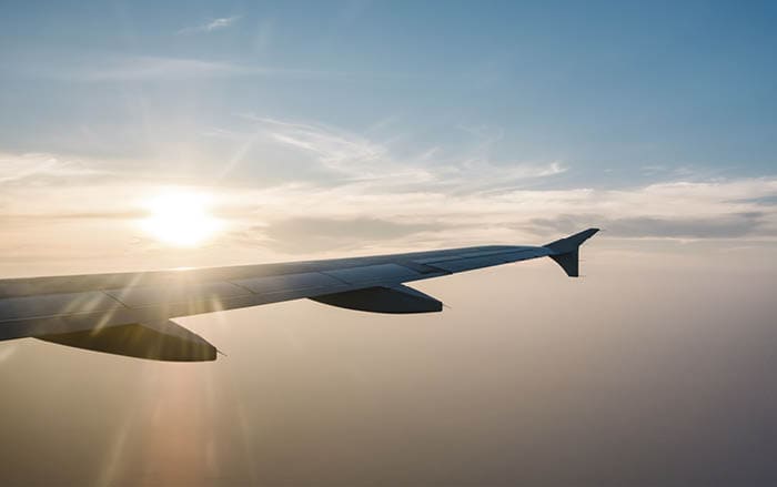 airplane wing and sunset on blue sky