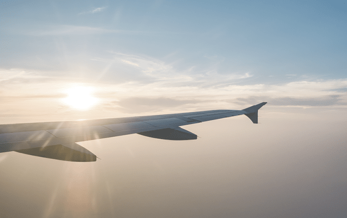 airplane wing and sunset on blue sky