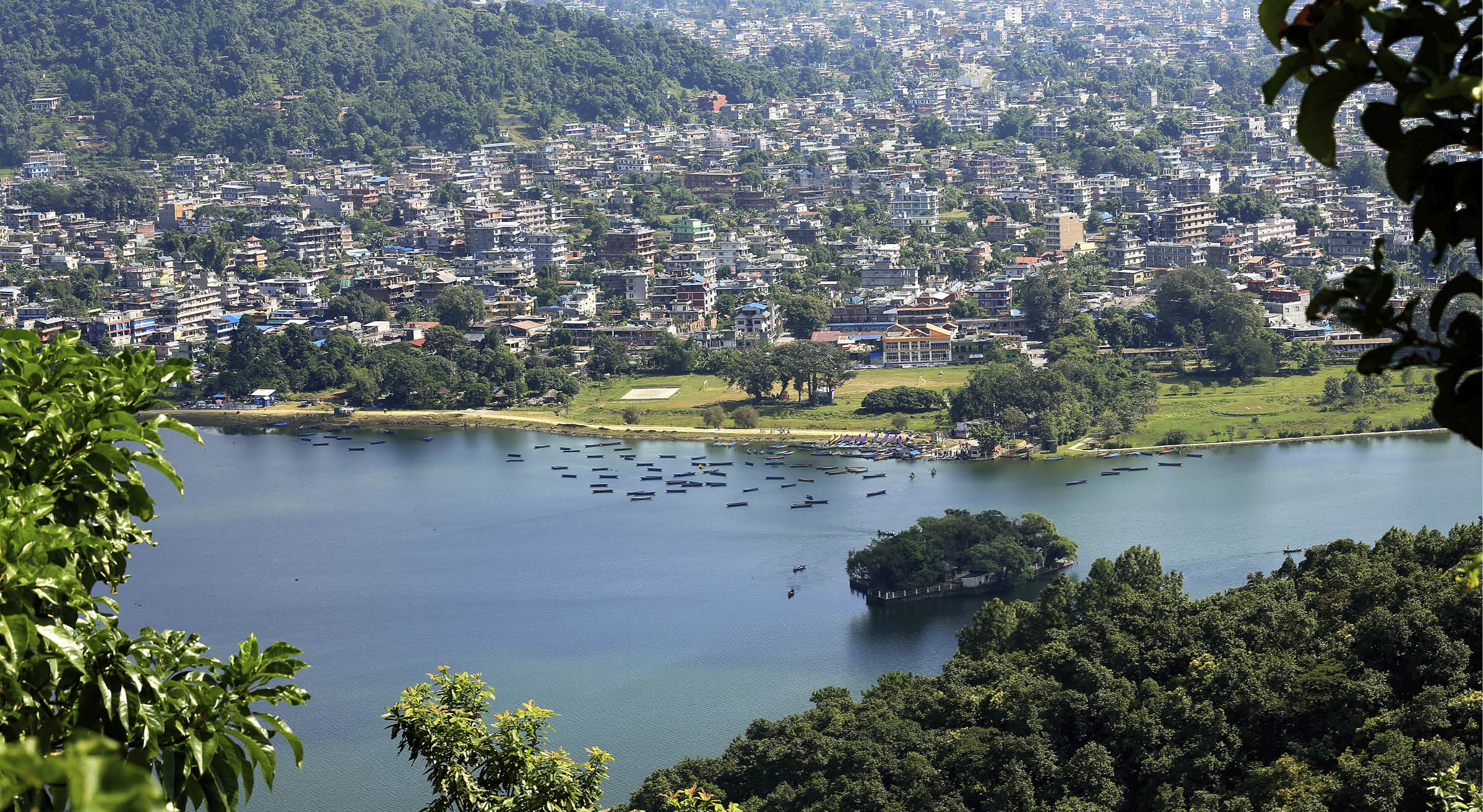 The 4.43 km2-784 ms.high Phewa tal-lake at foot of the Annapurnas range with Pokhara city seen from the way down Ananda Hill-Shanti Stupa-World Peace Pagoda. Kaski distr.-Gandaki zone-Nepal.