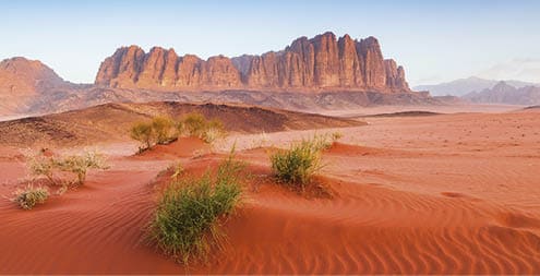 Wadi Rum Desert, Jordan. The red desert and Jabal Al Qattar mountain.